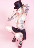  Kinky tattooed goth blonde in top, hat and heels.
