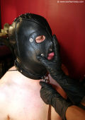 Slave with heavy leather mask